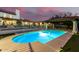 Sparkling pool at dusk with covered patio and fenced yard, perfect for entertaining at 44434 N 20Th St, New River, AZ 85087