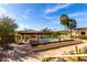 Backyard pool with decorative pond and a covered patio at 44434 N 20Th St, New River, AZ 85087