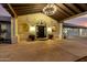 Stunning porte cochere with a decorative chandelier, arched windows, and lush potted plants at 44434 N 20Th St, New River, AZ 85087