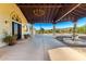 Porte cochere featuring a chandelier, elegant pillars, and a soothing fountain with desert views at 44434 N 20Th St, New River, AZ 85087