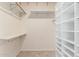 Spacious walk-in closet features shelving, custom storage and rod for hanging clothes at 44434 N 20Th St, New River, AZ 85087