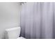 Bathroom features a modern toilet and a stylish gray textured shower curtain at 4444 E Paradise Village N Pkwy # 132, Phoenix, AZ 85032