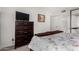 Bedroom features a wooden dresser with TV and stylish floral bedding at 4444 E Paradise Village N Pkwy # 132, Phoenix, AZ 85032