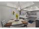 Charming dining area with modern lighting fixture, neutral colors, and a view into the updated kitchen at 4444 E Paradise Village N Pkwy # 132, Phoenix, AZ 85032