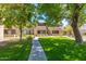 Beautifully landscaped grounds with mature trees, green grass, and walkways, creating a serene environment at 4444 E Paradise Village N Pkwy # 132, Phoenix, AZ 85032