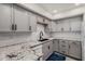Modern kitchen equipped with gray cabinetry, granite countertops, and stainless steel appliances for seamless cooking at 4444 E Paradise Village N Pkwy # 132, Phoenix, AZ 85032