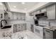 Stylish kitchen features modern gray cabinets, granite countertops, and stainless steel appliances for a contemporary look at 4444 E Paradise Village N Pkwy # 132, Phoenix, AZ 85032