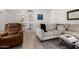 Cozy living room featuring a sectional sofa, recliner, and a view towards the dining and kitchen areas at 4444 E Paradise Village N Pkwy # 132, Phoenix, AZ 85032