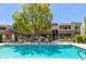 Community pool offers a refreshing escape on a hot day, with lounge chairs and shade at 4444 E Paradise Village N Pkwy # 132, Phoenix, AZ 85032