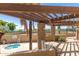 Private spa offering a relaxing experience, shaded by a wooden pergola and lush landscaping at 4444 E Paradise Village N Pkwy # 132, Phoenix, AZ 85032