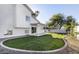 Spacious backyard featuring lush lawn, covered patio and desert landscaping at 4748 E Redfield Rd, Phoenix, AZ 85032