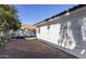 Backyard showcases desert landscaping, a white fence and a view of the home's exterior at 4748 E Redfield Rd, Phoenix, AZ 85032