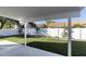 View of the backyard featuring a covered patio, green lawn and privacy wall at 4748 E Redfield Rd, Phoenix, AZ 85032