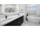 Luxurious bathroom with dual sinks, soaking tub, and a glass-enclosed shower at 4748 E Redfield Rd, Phoenix, AZ 85032