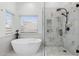 Bright bathroom featuring a modern soaking tub, sleek shower and neutral tones at 4748 E Redfield Rd, Phoenix, AZ 85032