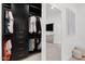 Organized walk-in closet with dark wood storage and full-length mirror at 4748 E Redfield Rd, Phoenix, AZ 85032