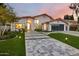 Striking exterior elevation with a tile roof, manicured front yard, stone paver driveway, and turf accents at 4748 E Redfield Rd, Phoenix, AZ 85032