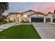 Stunning home featuring a landscaped yard, modern garage door, and beautiful architecture at 4748 E Redfield Rd, Phoenix, AZ 85032
