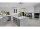 Contemporary kitchen featuring a kitchen island with seating, stainless appliances and modern lighting at 4748 E Redfield Rd, Phoenix, AZ 85032