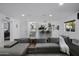 Open-concept living room with modern decor, leading to kitchen with island seating at 4748 E Redfield Rd, Phoenix, AZ 85032