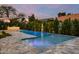 Backyard oasis featuring a sparkling pool with water features and lush landscaping at 4748 E Redfield Rd, Phoenix, AZ 85032