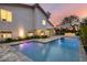 Exterior view of a stunning pool with travertine decking at twilight at 4748 E Redfield Rd, Phoenix, AZ 85032