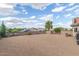 Expansive gravel backyard featuring mature trees, desert landscaping, and a serene atmosphere for outdoor enjoyment at 508 N Sierra Vista Dr, Wickenburg, AZ 85390