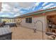 Spacious backyard featuring a hot tub, covered patio, and low-maintenance desert landscaping at 508 N Sierra Vista Dr, Wickenburg, AZ 85390