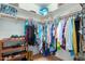 Walk-in closet providing ample storage space and organization with clothes on hangers at 508 N Sierra Vista Dr, Wickenburg, AZ 85390