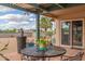 Charming covered patio with tile flooring, outdoor seating, and a beautiful view of the surrounding landscape at 508 N Sierra Vista Dr, Wickenburg, AZ 85390