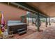 Relaxing patio with hot tub, pergola, and hanging chairs for outdoor enjoyment at 508 N Sierra Vista Dr, Wickenburg, AZ 85390