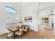 Dining area with a wood table, seating for six, and light hardwood floors at 6408 E Marilyn Rd, Scottsdale, AZ 85254