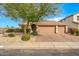 Attractive single-story home featuring a two-car garage, a well-maintained yard, and desert landscaping at 6408 E Marilyn Rd, Scottsdale, AZ 85254