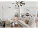 Bright living room with a modern fireplace, neutral furniture, and access to the kitchen at 6408 E Marilyn Rd, Scottsdale, AZ 85254