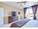 Main bedroom with a view of the backyard pool, television, and large dresser at 6579 S Classic Way, Gilbert, AZ 85298