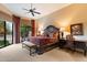 Tranquil main bedroom with a large window, dark furniture, bench, and elegant bedding at 7327 E Via Estrella Ave, Scottsdale, AZ 85258