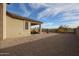 Wide angle shot of the home's rockscaped backyard including covered patio and landscaping at 7735 W Agora Ln, Phoenix, AZ 85043