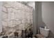 Stylish bathroom with a patterned shower curtain and a modern, efficient toilet at 7735 W Agora Ln, Phoenix, AZ 85043
