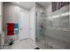Shower room featuring a modern glass enclosure and pebble flooring at 7735 W Agora Ln, Phoenix, AZ 85043