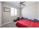 Bright bedroom featuring a window with blinds and neutral decor at 7735 W Agora Ln, Phoenix, AZ 85043