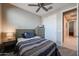 Comfortable bedroom with a ceiling fan, a window with blinds and a closet for storage at 7735 W Agora Ln, Phoenix, AZ 85043
