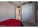 Bedroom featuring a closet with paneled doors and carpet flooring at 7735 W Agora Ln, Phoenix, AZ 85043