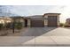 Inviting single-Gathering home featuring a three-car garage and manicured landscaping at 7735 W Agora Ln, Phoenix, AZ 85043