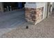 Exterior close up featuring a brick wall, pebbles, and the garage entrance at 7735 W Agora Ln, Phoenix, AZ 85043