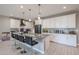 Bright kitchen with white cabinetry, granite countertops, and a large center island at 7735 W Agora Ln, Phoenix, AZ 85043