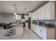 Bright kitchen features white cabinets, granite countertops, stainless steel appliances, and a stylish tiled backsplash at 7735 W Agora Ln, Phoenix, AZ 85043