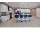 Stylish kitchen with white cabinets, granite counters, and seating at the island at 7735 W Agora Ln, Phoenix, AZ 85043