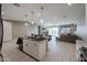 Contemporary kitchen featuring a center island, modern lighting, and seamless flow to the living area at 7735 W Agora Ln, Phoenix, AZ 85043