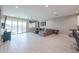 Bright and airy living room with sliding glass doors, tile floors, and a comfortable sectional sofa at 7735 W Agora Ln, Phoenix, AZ 85043