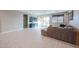 Spacious living room featuring tiled flooring, a ceiling fan, and sliding glass doors for natural light at 7735 W Agora Ln, Phoenix, AZ 85043